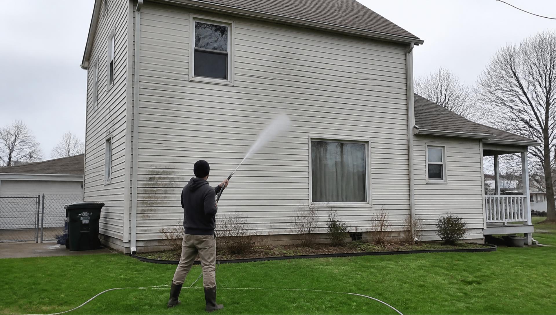 Pressure washing the siding of a suburban home in Stark County, Ohio